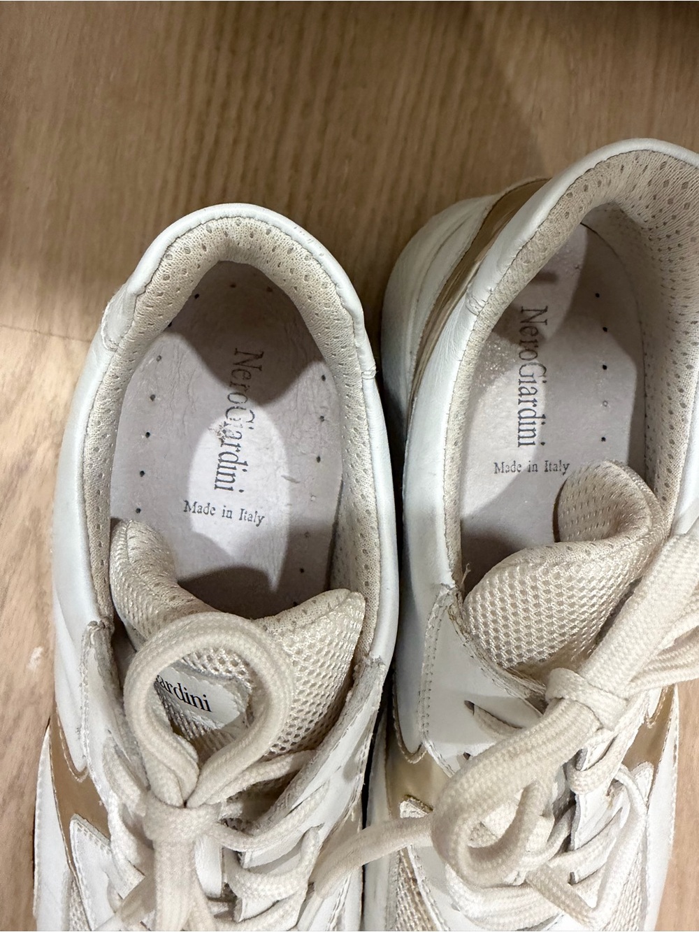 Nero Giardini woman’s Cream and Gold Accent Sneakers